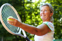 Getting ready to serve - Tennis technique. Senior woman preparin